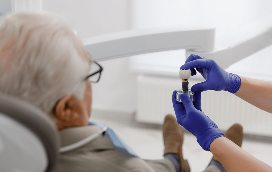 Dentist showing tooth model to a patient