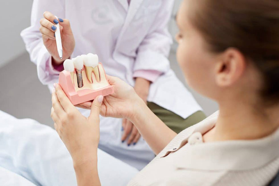 Doctor showing teeth model to patient