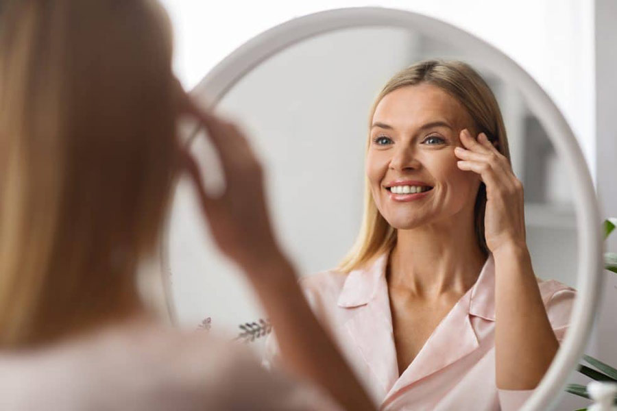 Woman looking at herself in the mirror