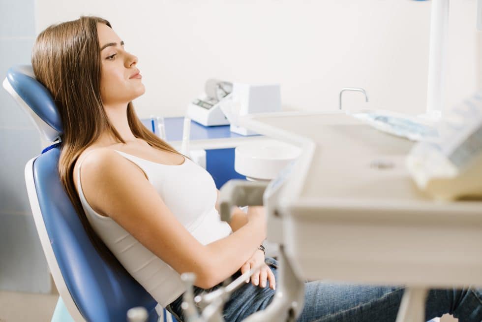 anxious woman sitting in dental chair