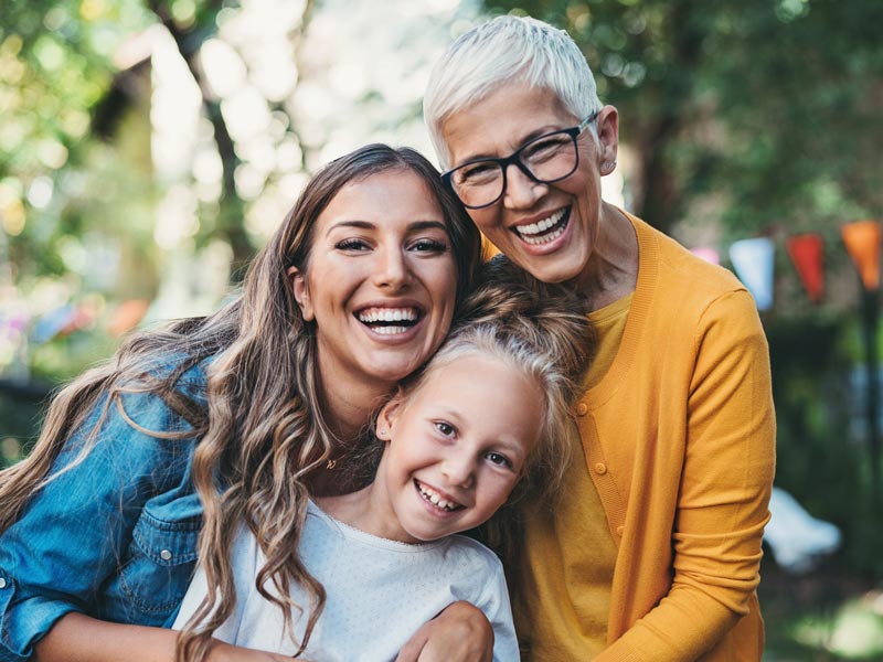 three generations of women smiling